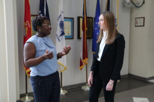 Two Mediation Clinic students are standing in the courthouse talking. 
